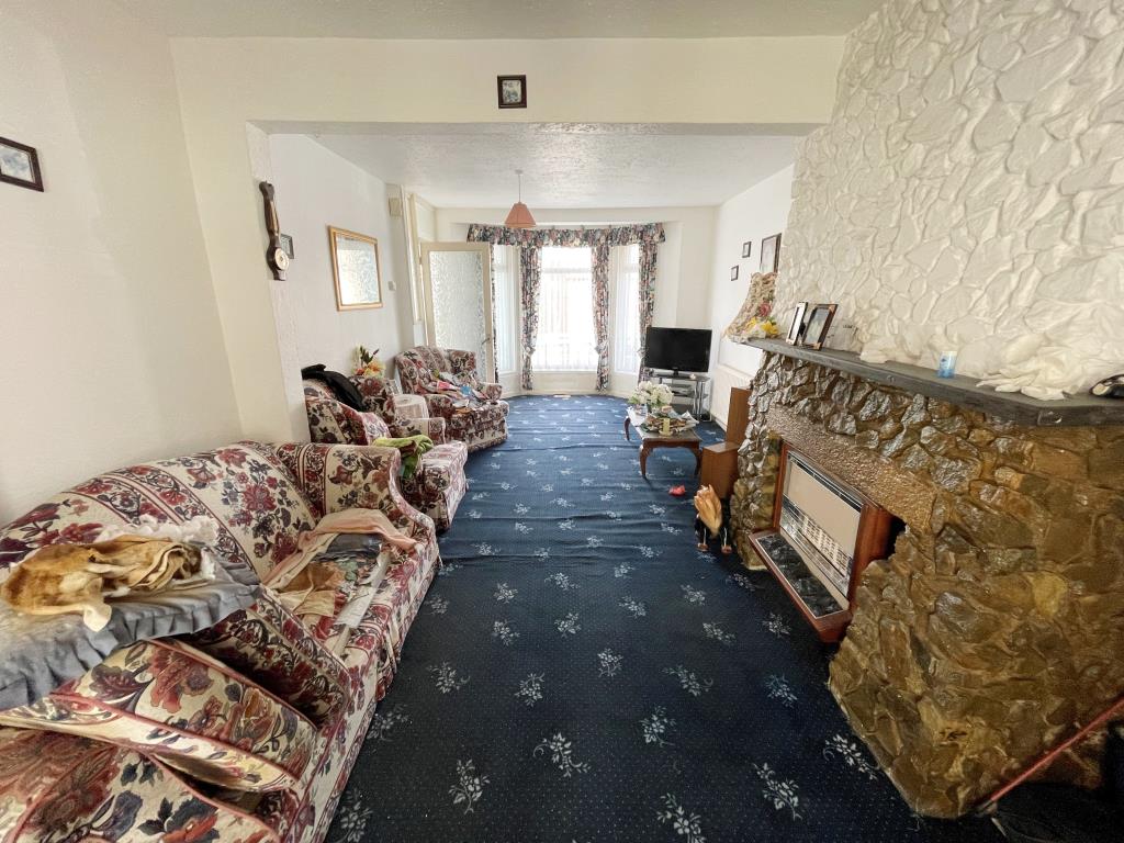Lot: 63 - TWO-BEDROOM HOUSE FOR REFURBISHMENT - Living room with bay window